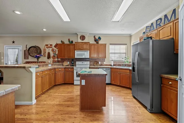 a kitchen with stainless steel appliances a refrigerator a sink dishwasher stove and oven