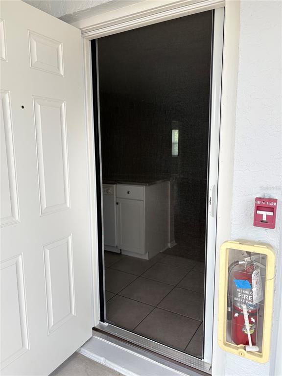26485 Rampart Boulevard, Unit D1 Punta Gorda, FL 33983 - Photo 27 of 29 a view of a hallway with wooden floor and front door