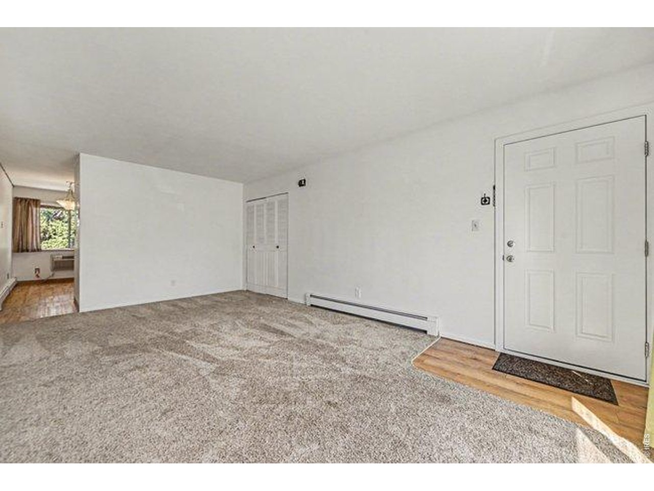 905 East Swallow Road, Unit 4 Fort Collins, CO 80525 - Photo 5 of 25 a view of an empty room and wooden floor