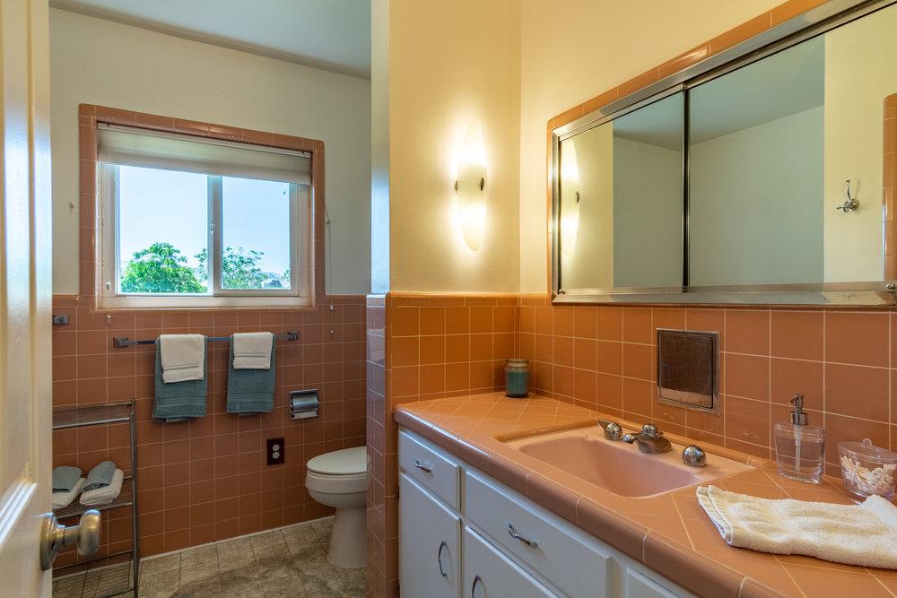 1177 Orchard Road Hollister, CA 95023 - Photo 22 of 79 a bathroom with a granite countertop toilet a sink and a mirror