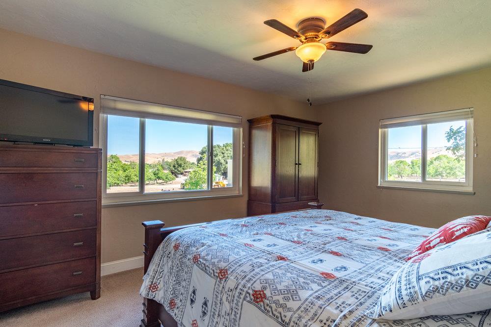1177 Orchard Road Hollister, CA 95023 - Photo 26 of 79 a bedroom with a bed and a chandelier