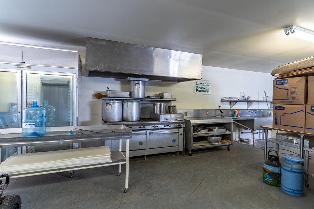1177 Orchard Road Hollister, CA 95023 - Photo 37 of 79 a kitchen with kitchen island a stove and a sink