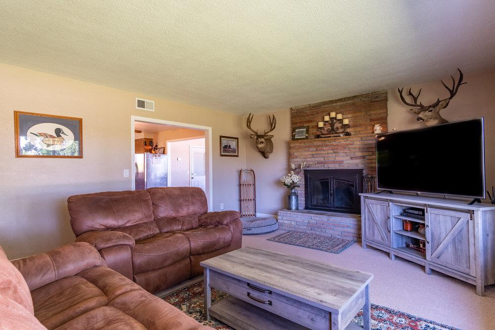 1177 Orchard Road Hollister, CA 95023 - Photo 8 of 79 a living room with furniture and a flat screen tv
