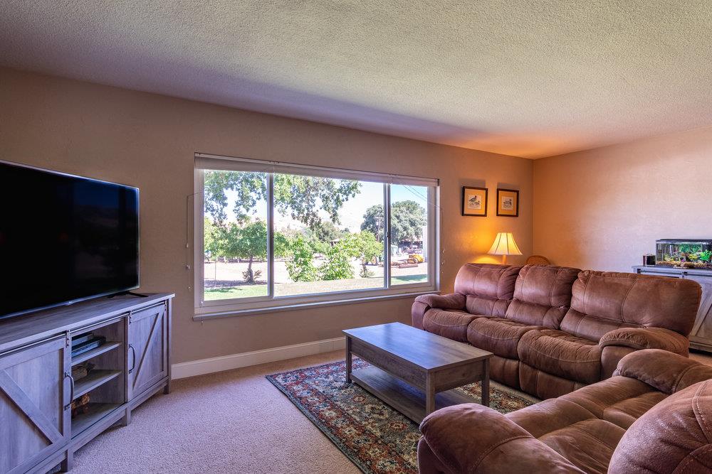 1177 Orchard Road Hollister, CA 95023 - Photo 9 of 79 a living room with furniture a flat screen tv and a window