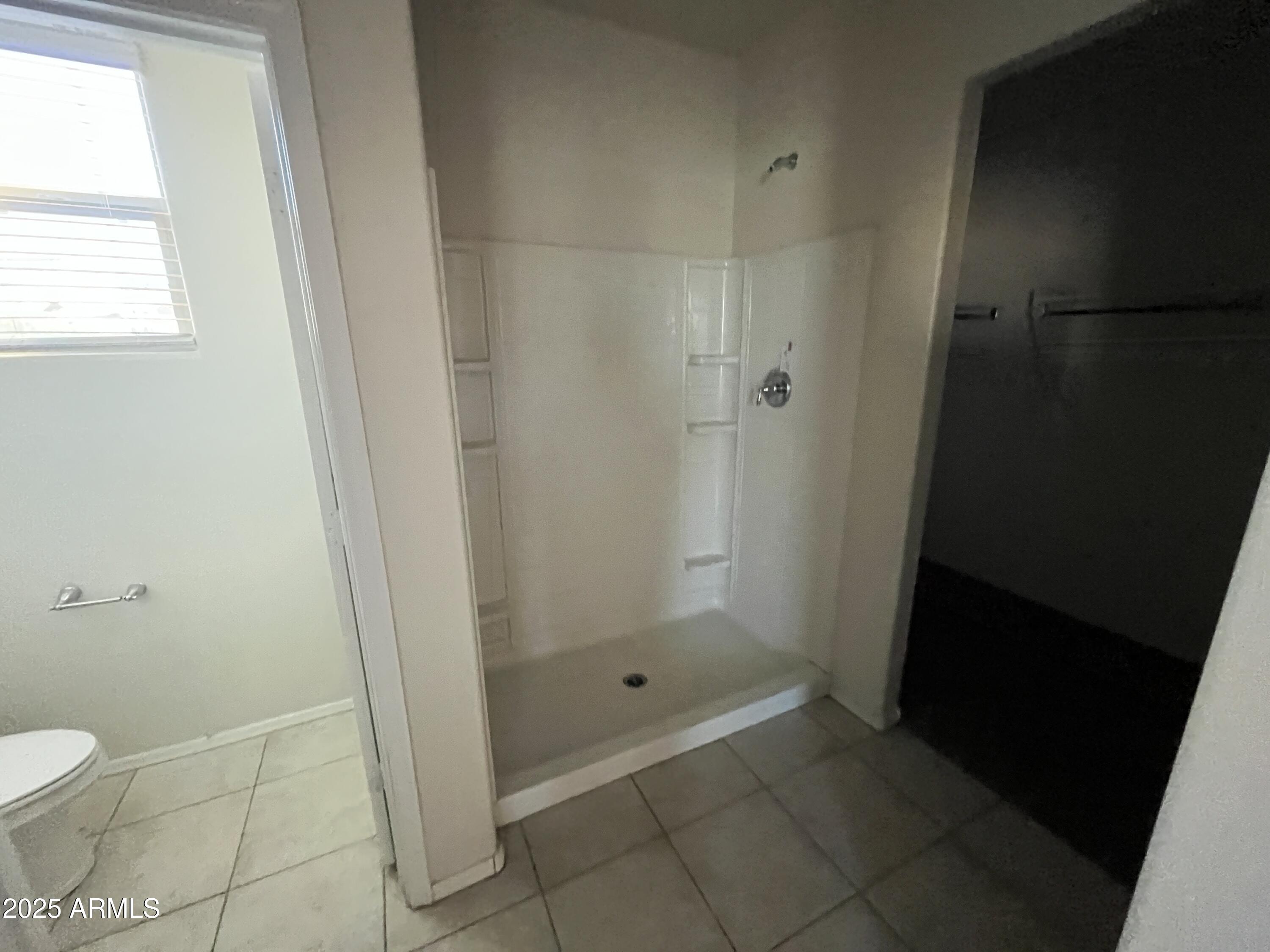 30968 West Picadilly Road Buckeye, AZ 85396 - Photo 11 of 21 a bathroom with a granite countertop shower and a toilet