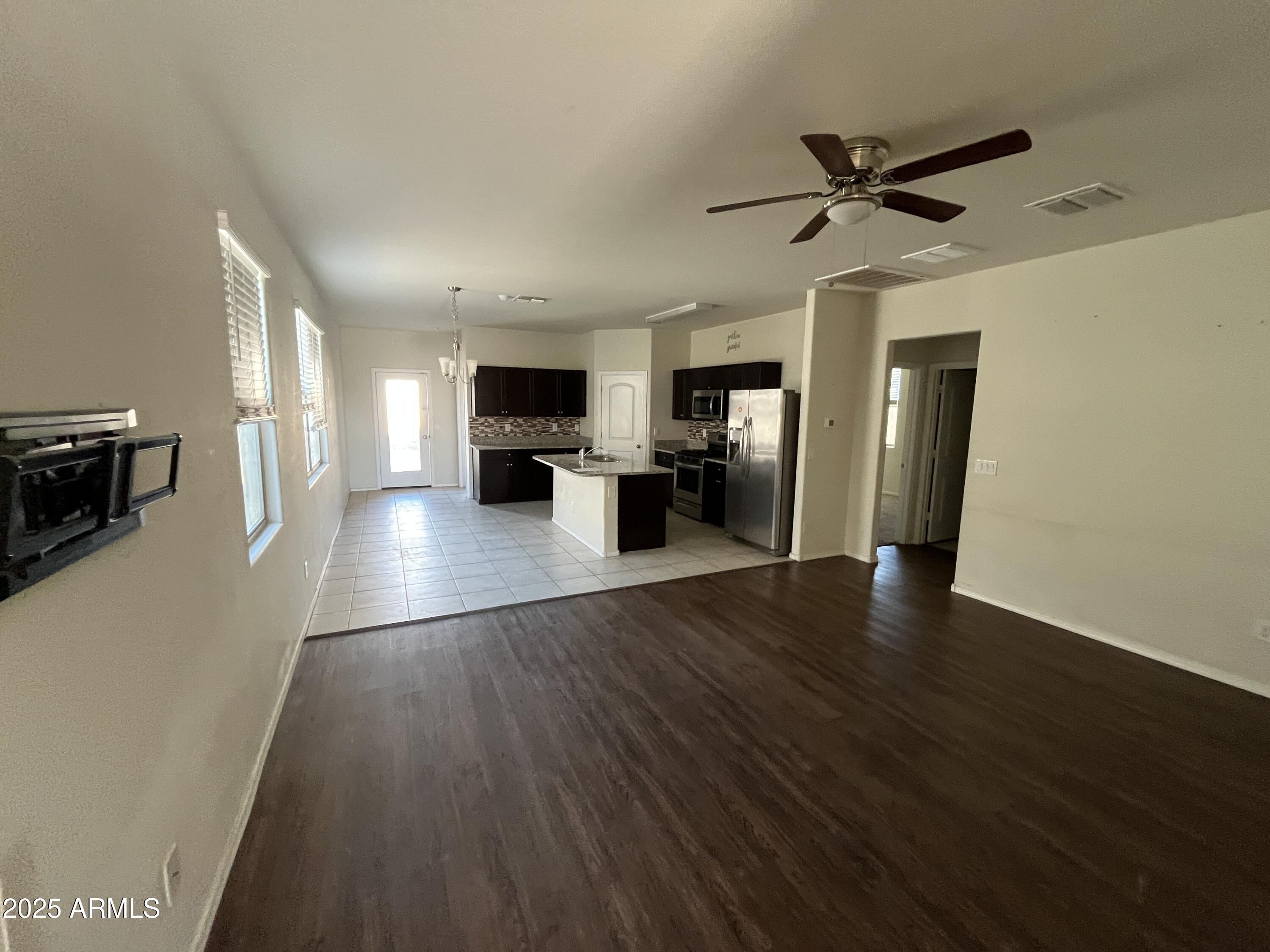 30968 West Picadilly Road Buckeye, AZ 85396 - Photo 4 of 21 a view of a living room hardwood floor and a window