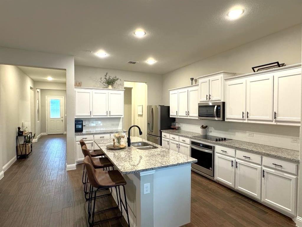 1455 Radecke Road Krum, TX 76249 - Photo 4 of 18 a kitchen with sink stove and chairs