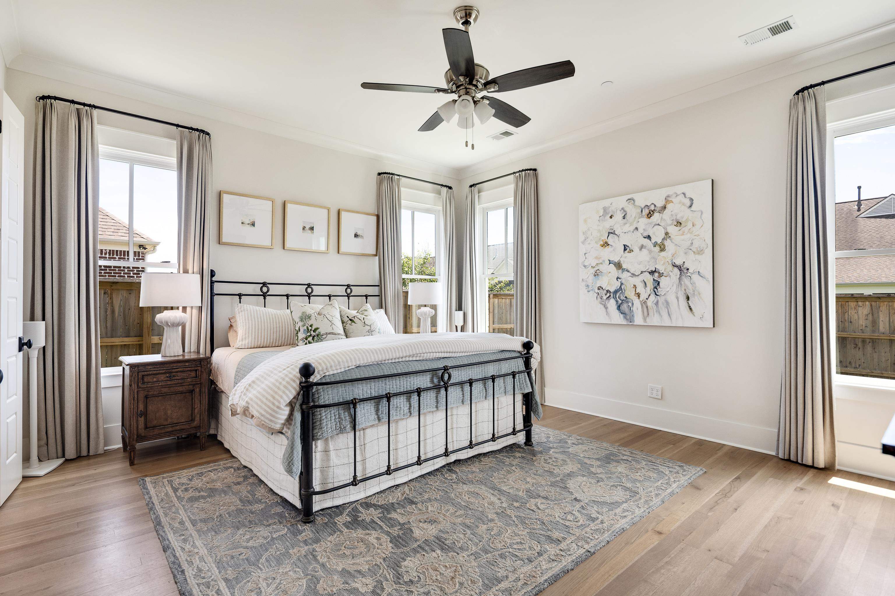 100 Sunflower View Road Piperton, TN 38017 - Photo 17 of 29 Spacious bedroom featuring light wood-finish flooring, multiple windows with natural light, and a ceiling fan
