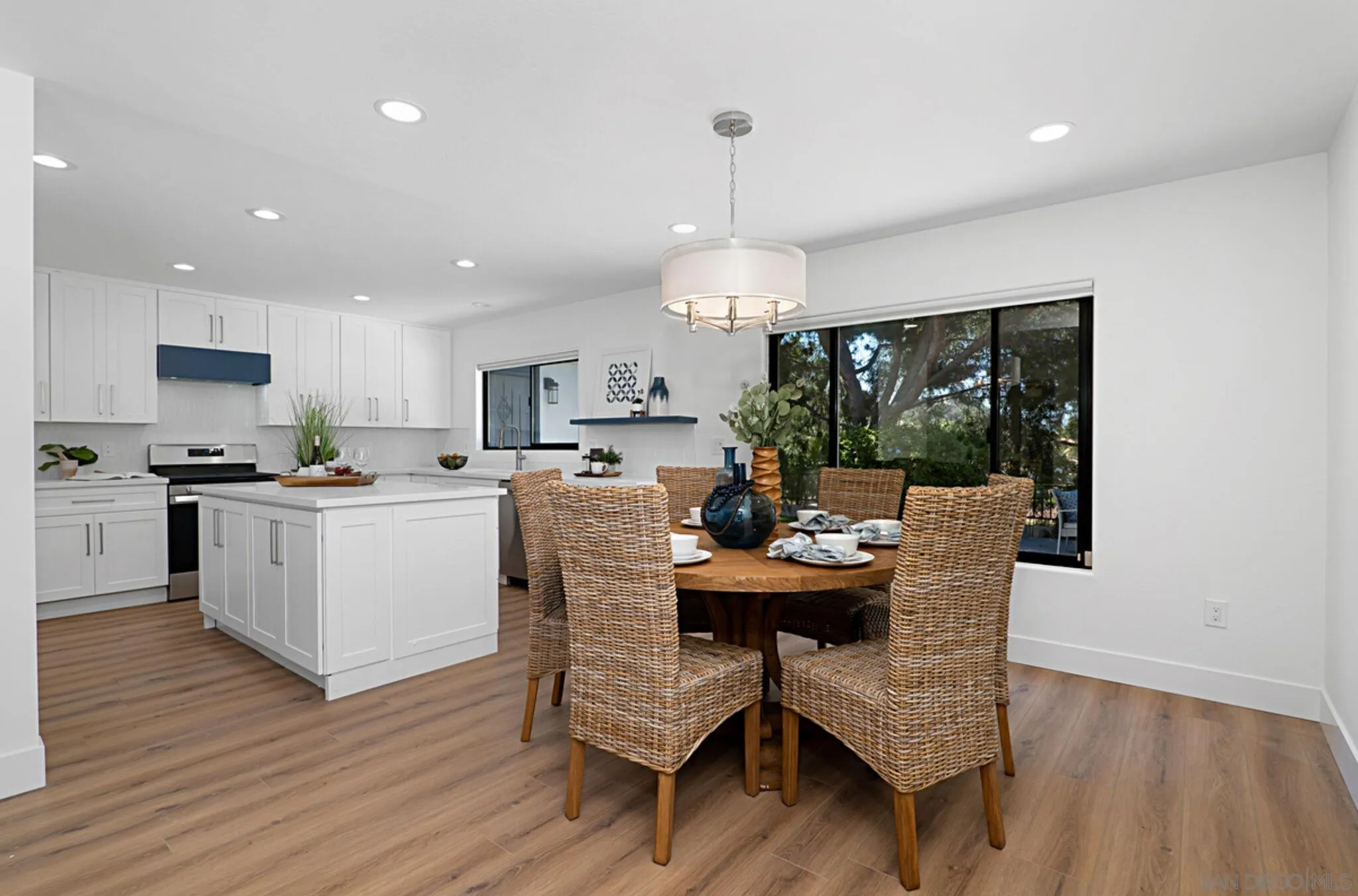 2282 Morgan Road Carlsbad, CA 92008 - Photo 11 of 28 a open dining room with kitchen island stainless steel appliances furniture a dining table and chairs