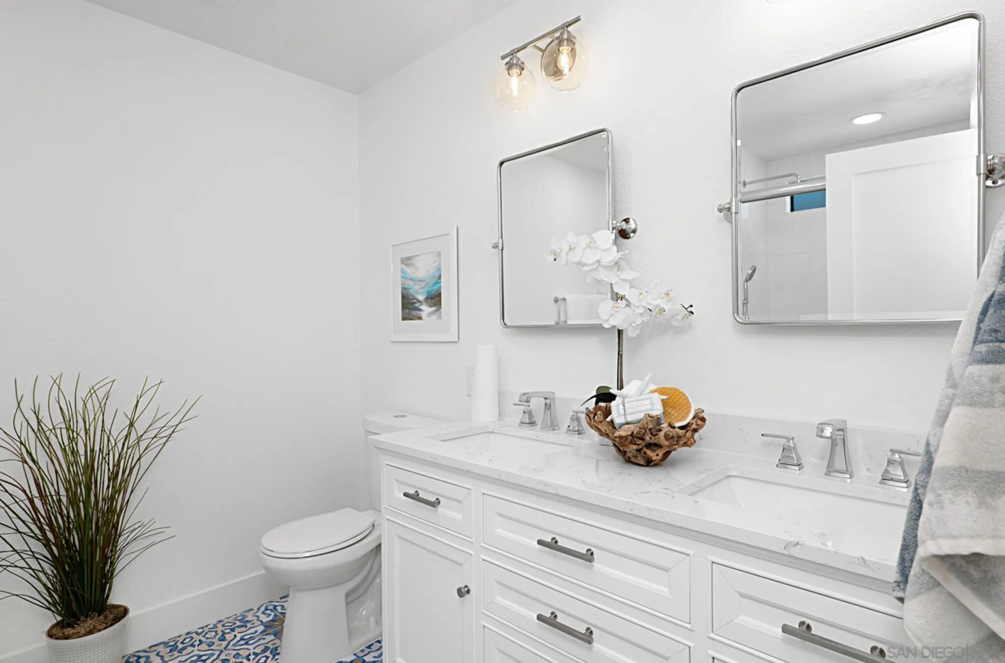 2282 Morgan Road Carlsbad, CA 92008 - Photo 17 of 28 a bathroom with a sink a toilet and a mirror