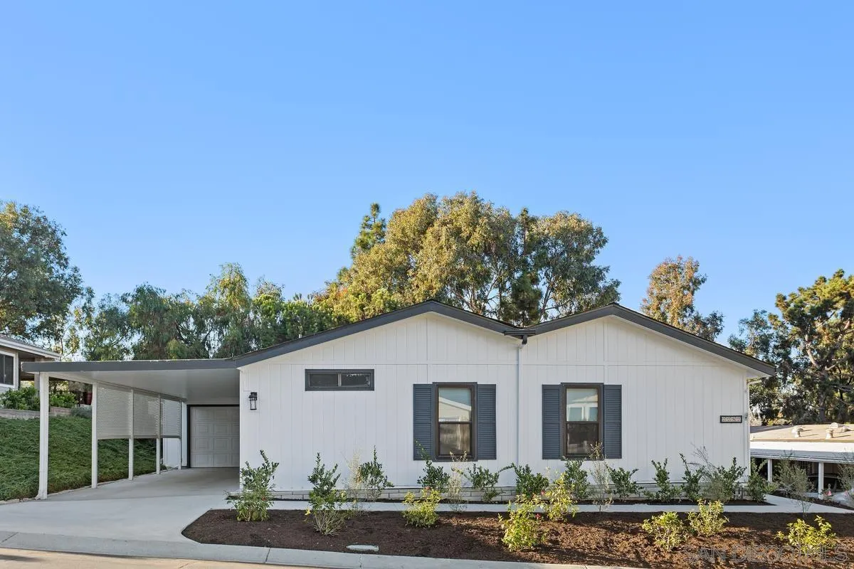 2282 Morgan Road Carlsbad, CA 92008 - Photo 3 of 28 a view of a white house next to a yard with plants and trees