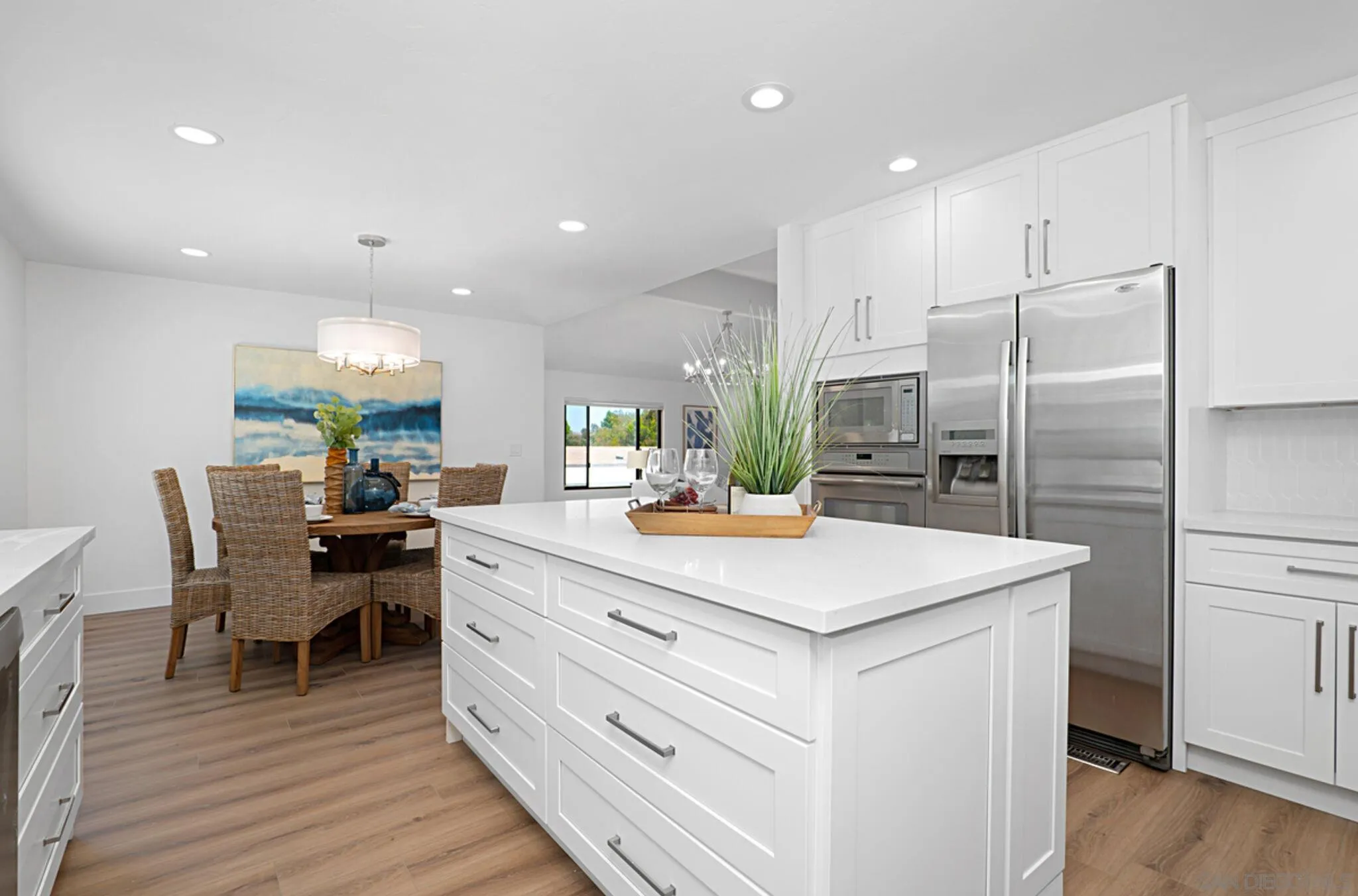 2282 Morgan Road Carlsbad, CA 92008 - Photo 10 of 28 a kitchen with kitchen island a sink stove and wooden floor