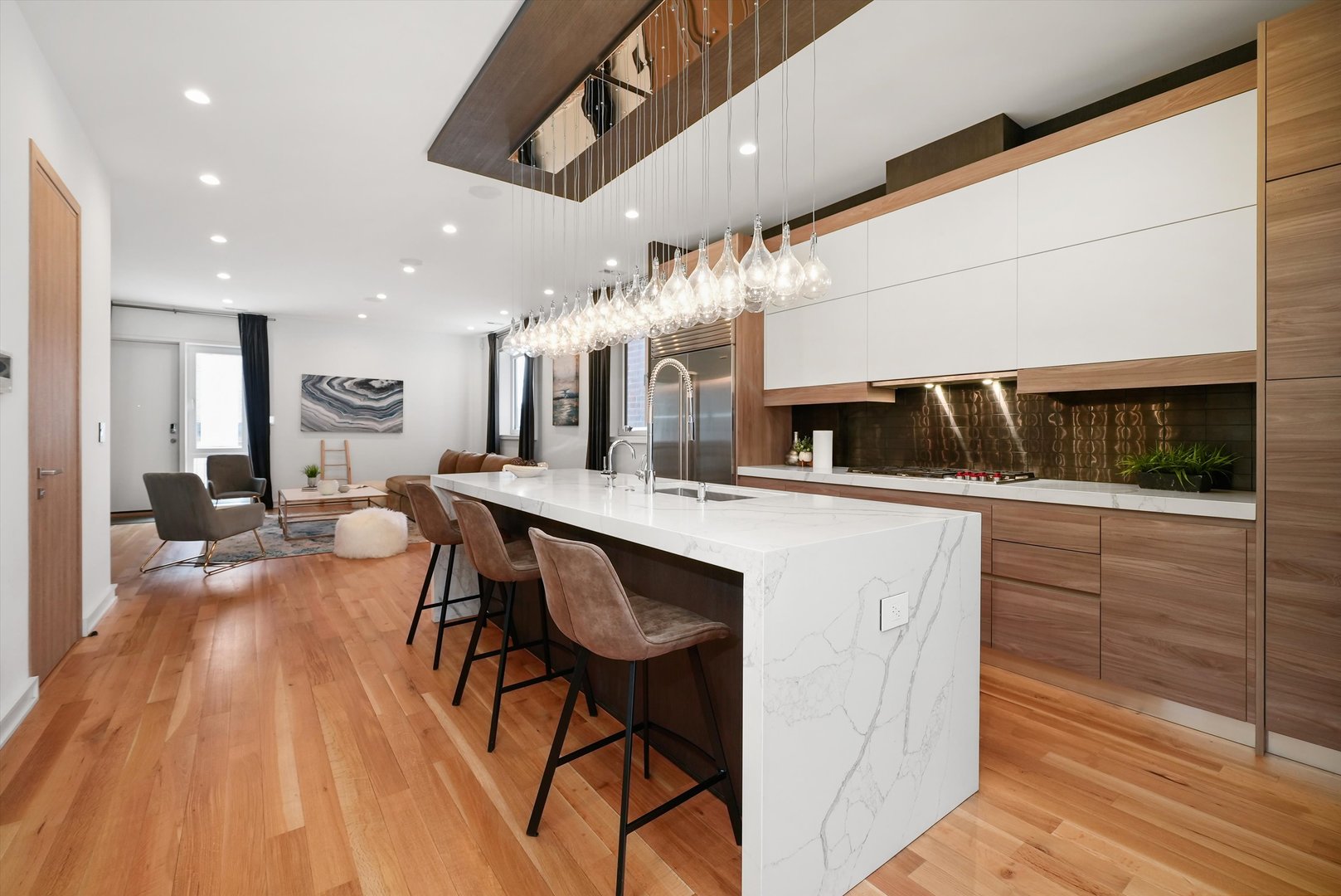 1605 West Ohio Street, Unit 2 Chicago, IL 60622 - Photo 11 of 38 a living room with stainless steel appliances kitchen island a table and chairs in it