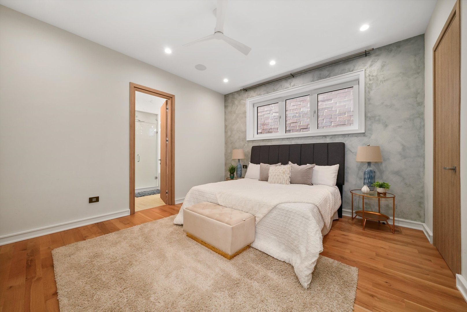 1605 West Ohio Street, Unit 2 Chicago, IL 60622 - Photo 26 of 38 a spacious bedroom with a bed and a night stand