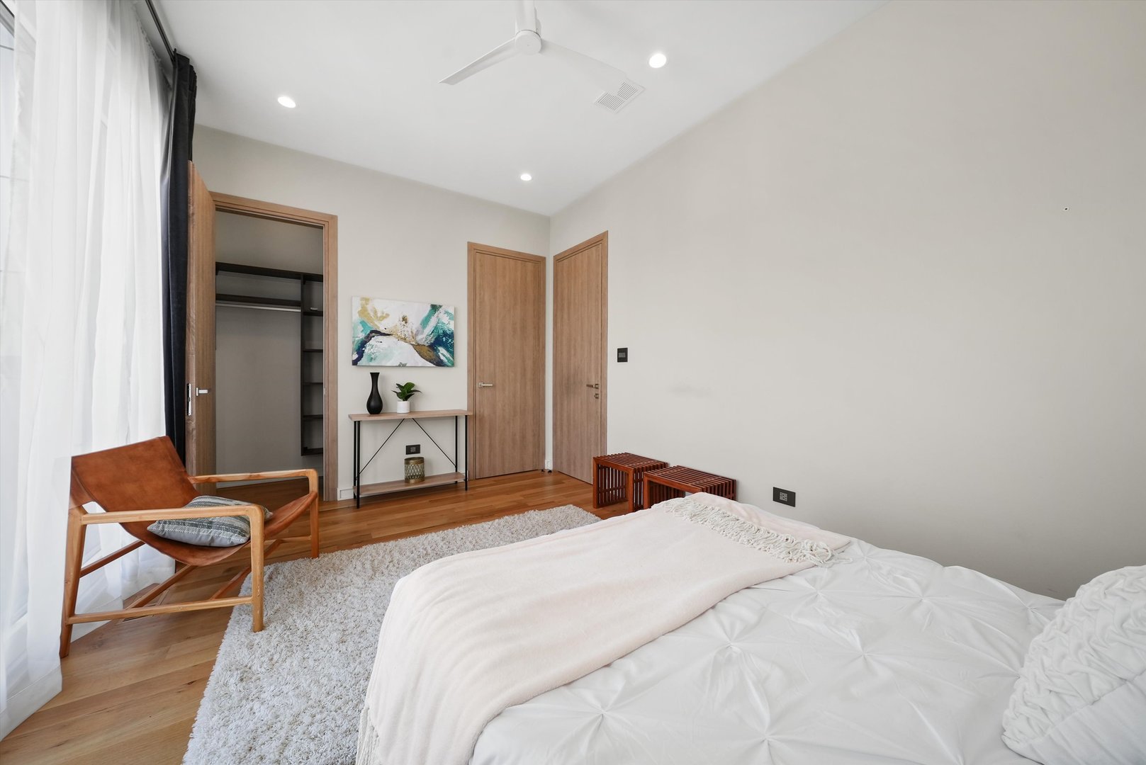 1605 West Ohio Street, Unit 2 Chicago, IL 60622 - Photo 32 of 38 a bedroom with a bed and a chair