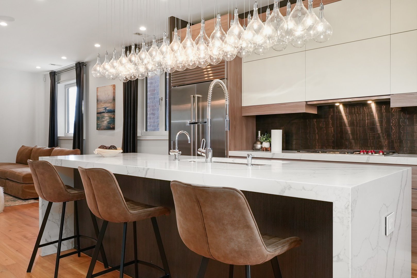 1605 West Ohio Street, Unit 2 Chicago, IL 60622 - Photo 6 of 38 a kitchen with a dining table chairs and white cabinets
