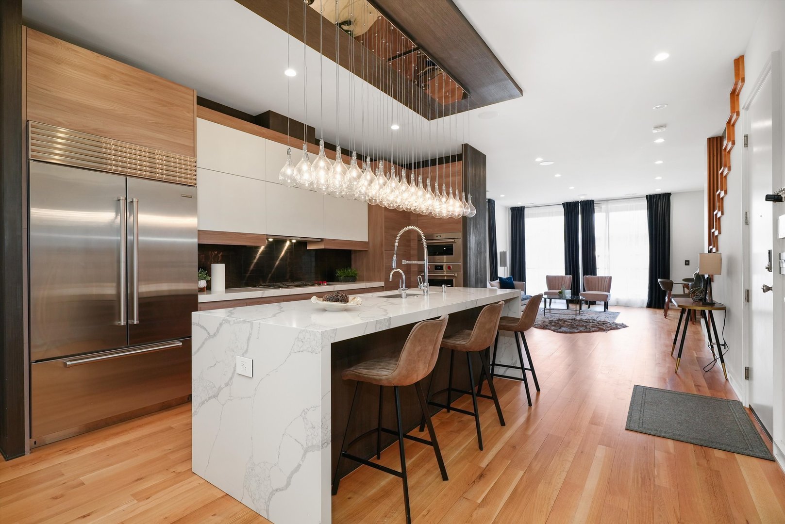 1605 West Ohio Street, Unit 2 Chicago, IL 60622 - Photo 9 of 38 a kitchen with stainless steel appliances a dining table chairs stove and refrigerator