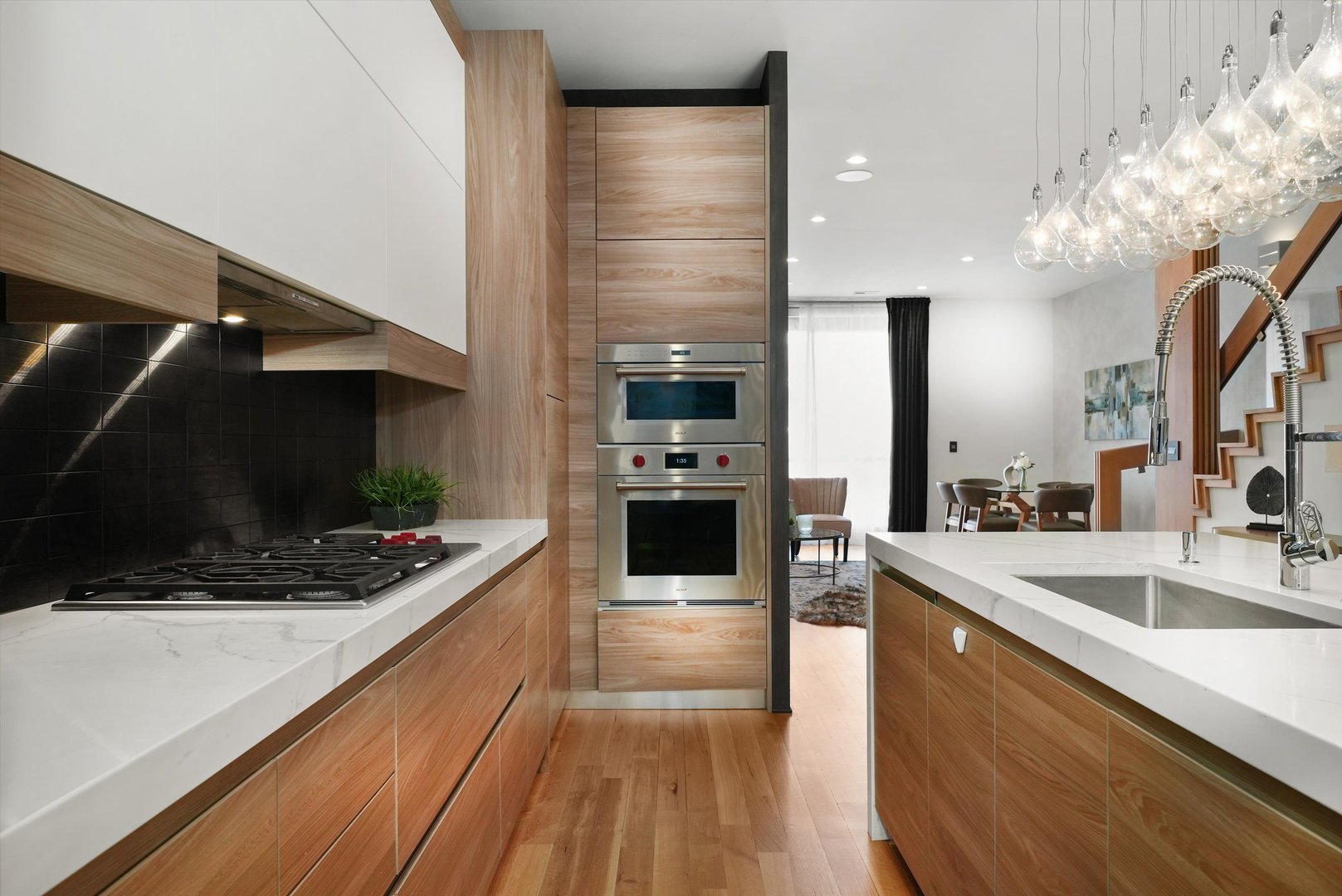 1605 West Ohio Street, Unit 2 Chicago, IL 60622 - Photo 10 of 38 a kitchen with stainless steel appliances kitchen island granite countertop a stove and a sink