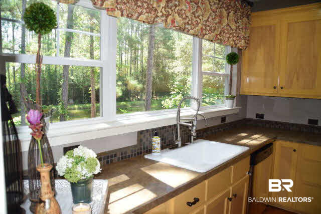 13848 Elmwood Court Stapleton, AL 36578 - Photo 4 of 27 What a beautiful view from your kitchen sink of the pond and side yard.