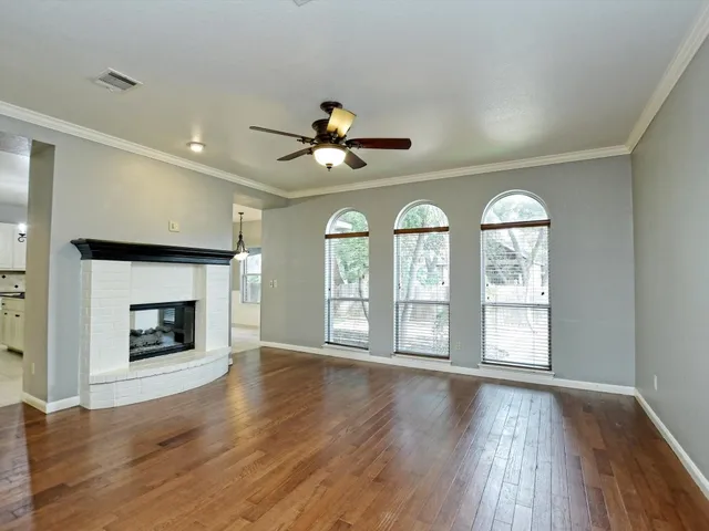 wooden floor in an empty room with a fireplace