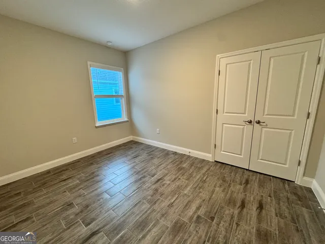 a view of a room with wooden floor and window