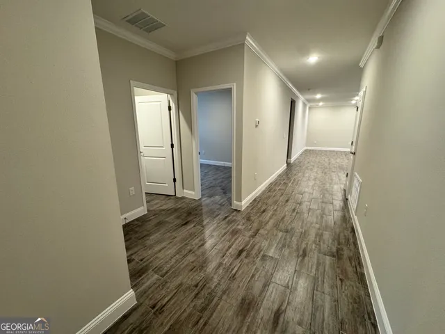 a view of hallway with wooden floor