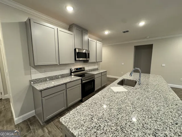 a kitchen with a sink stove and refrigerator