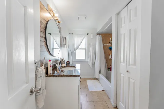 a very nice looking room with a large mirror next to a window