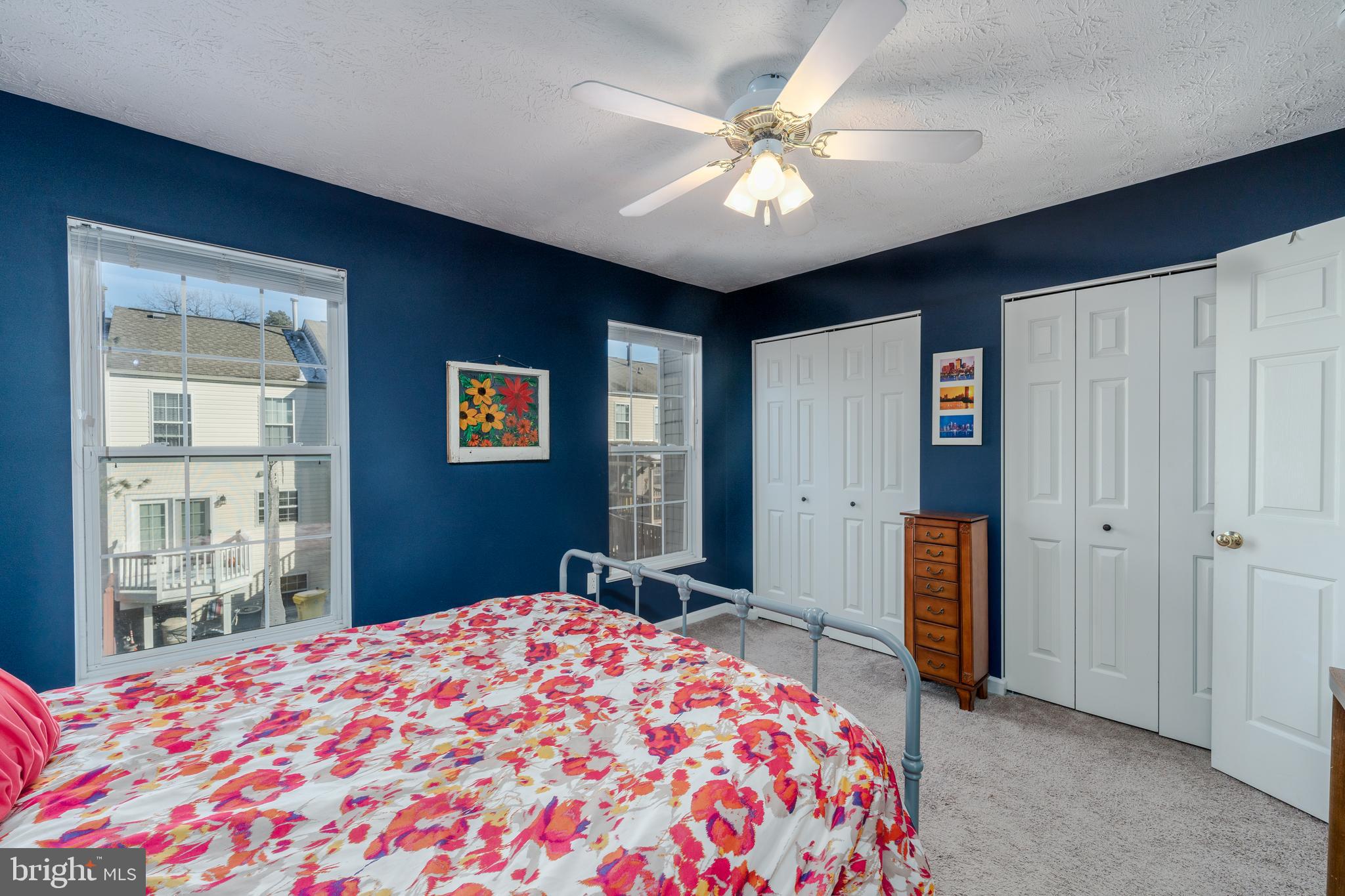 8303 Spadderdock Way Laurel, MD 20724 - Photo 11 of 25 a bedroom with a large bed and a chandelier
