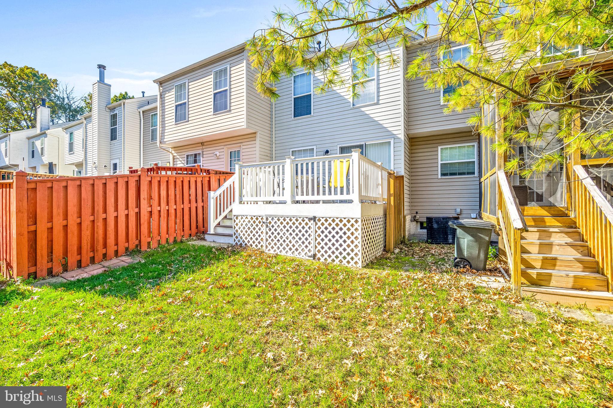 8303 Spadderdock Way Laurel, MD 20724 - Photo 20 of 25 a view of a house with a small yard and wooden fence