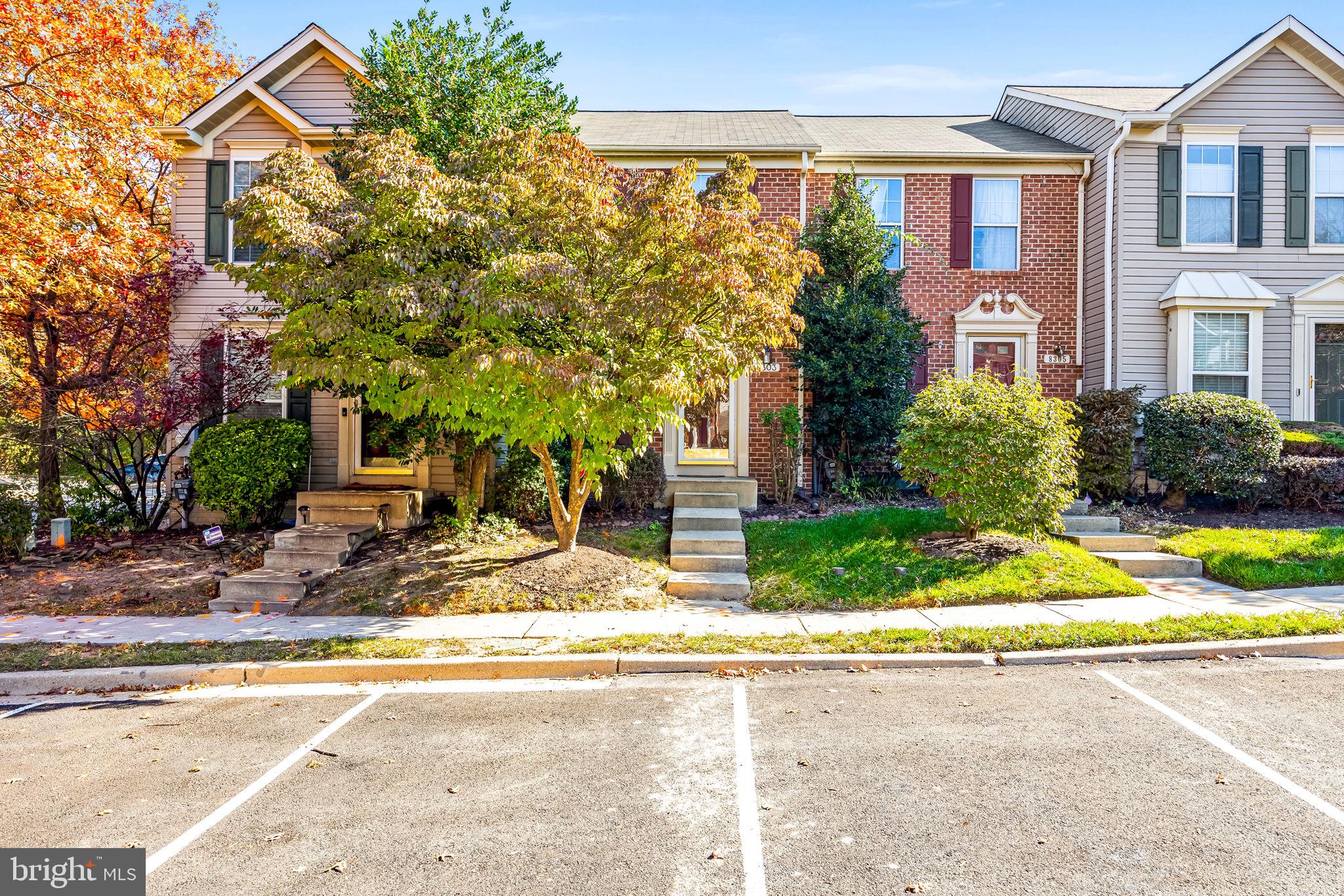 8303 Spadderdock Way Laurel, MD 20724 - Photo 22 of 25 a view of yellow house with a yard and plants
