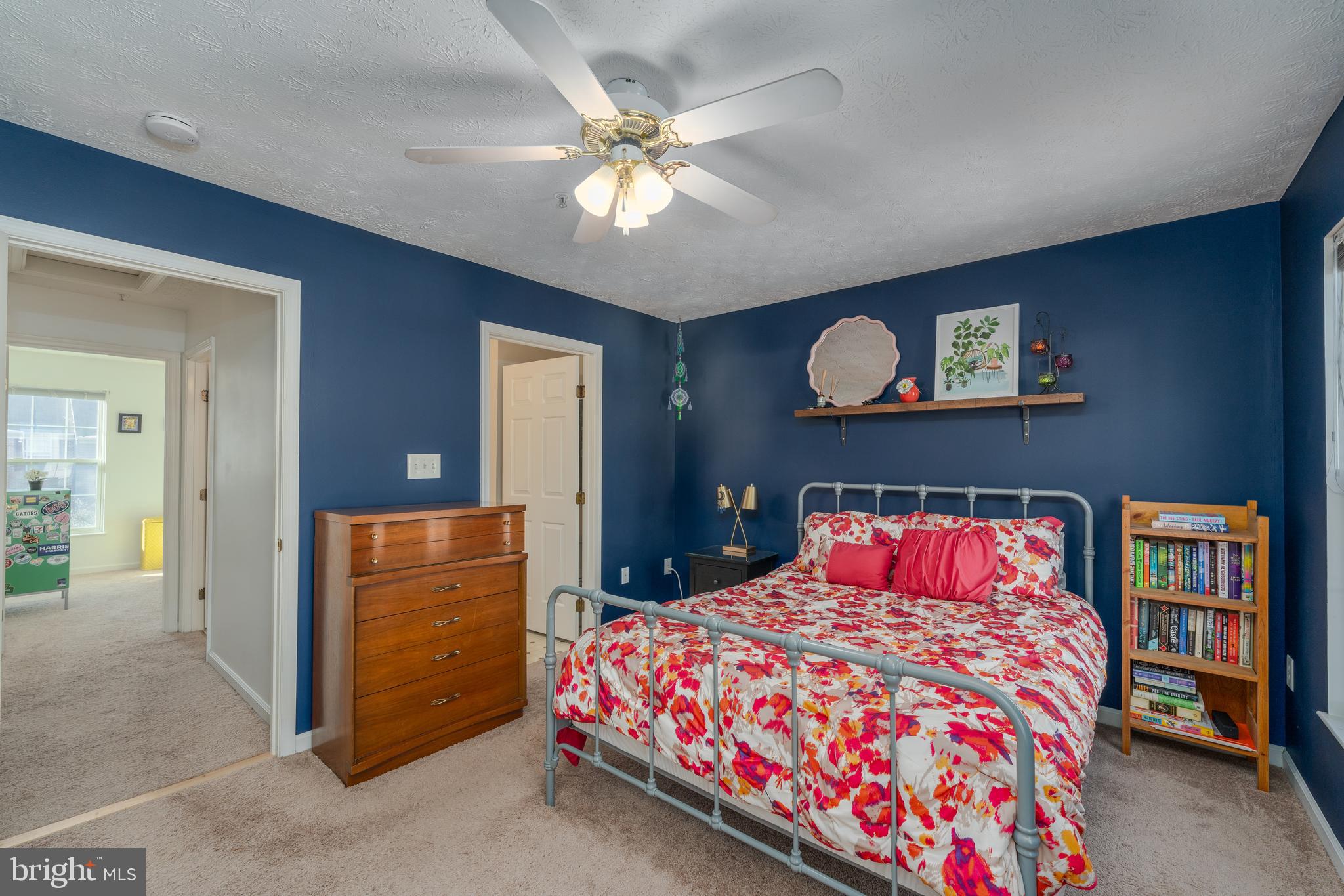 8303 Spadderdock Way Laurel, MD 20724 - Photo 10 of 25 a bedroom with a bed and a chandelier