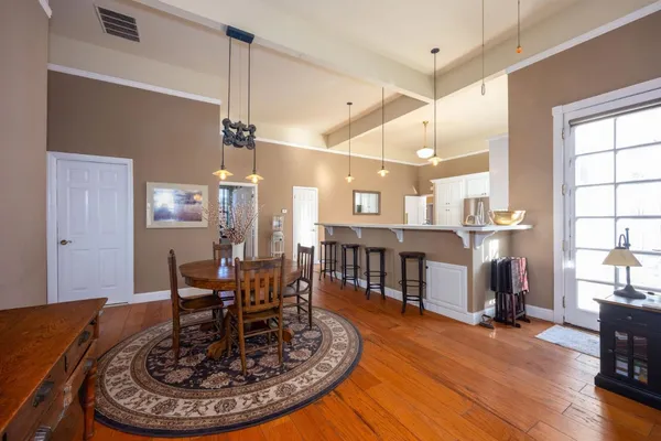 a view of a dining room with furniture window and wooden floor