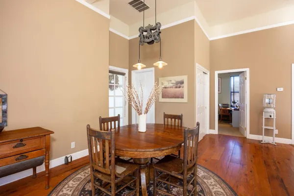 a view of a dining room with furniture large windows and wooden floor