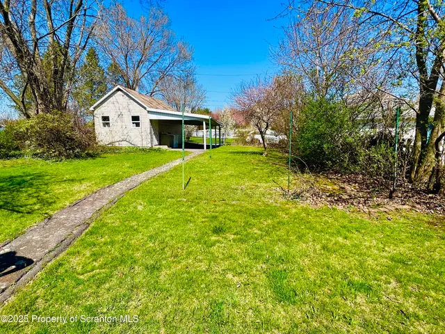 a white house sitting in middle of the grass