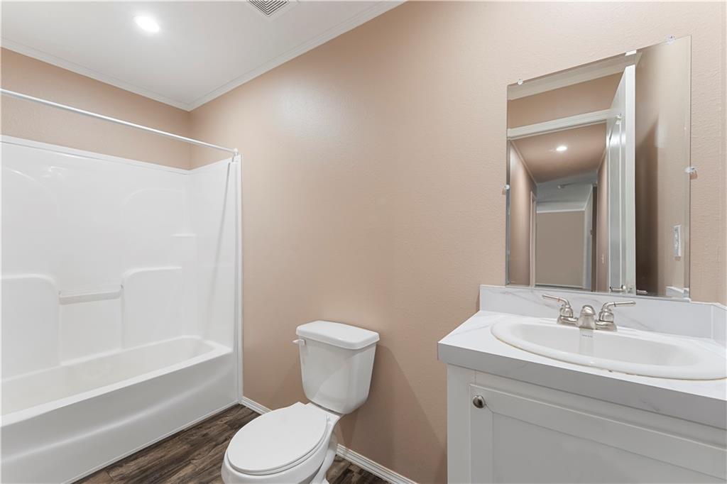 89 Ridge Road Seale, AL 36875 - Photo 30 of 46 Bathroom featuring a built-in tub and shower combination, vanity with an integrated sink, and wood-finish flooring