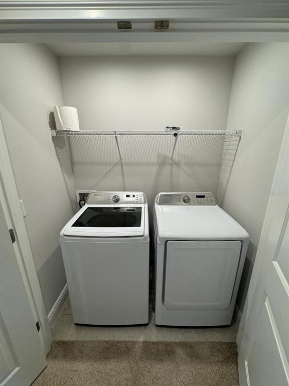 5912 Grand Sonata Avenue Lutz, FL 33558 - Photo 25 of 36 a utility room with dryer and washer