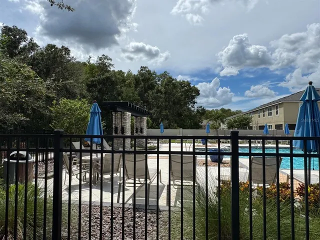 a view of a house with pool and a yard
