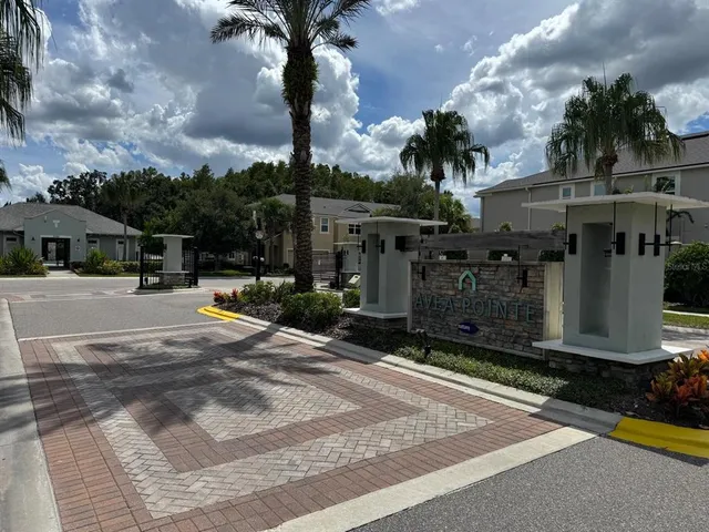 a view of a patio with a table chairs and a floor to ceiling window