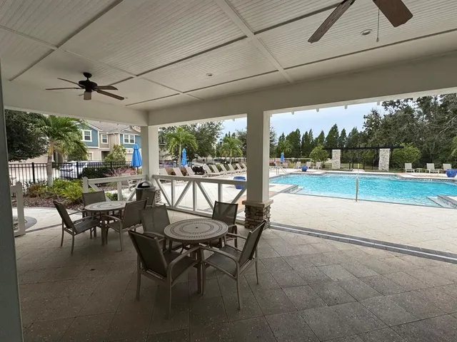 a view of a patio with a dining table and chairs