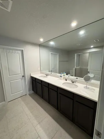 a bathroom with a double vanity sink a and mirror