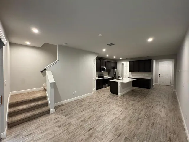 a view of kitchen with cabinets and wooden floor