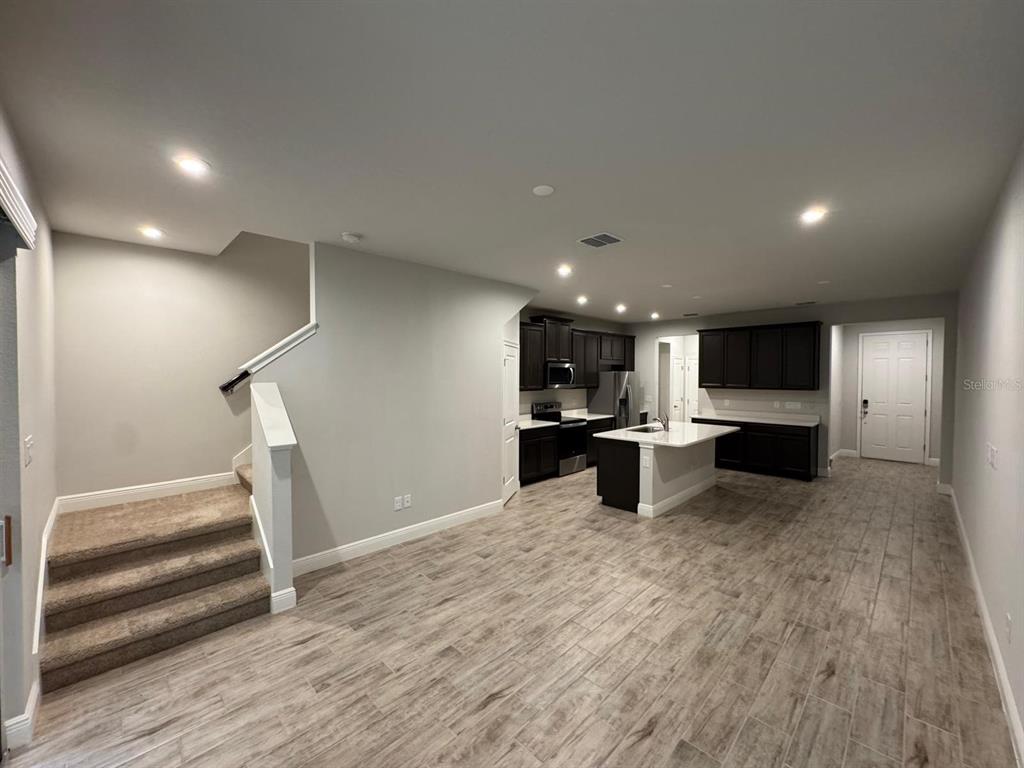 5912 Grand Sonata Avenue Lutz, FL 33558 - Photo 8 of 36 a view of kitchen with cabinets and wooden floor
