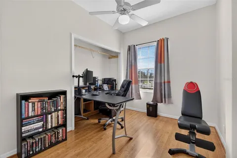 a view of a workspace with furniture and a bookshelf