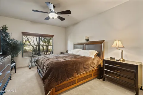 a bedroom with a bed and a chandelier