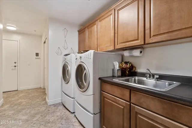 a utility room with sink dryer and washer