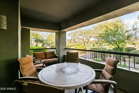 a view of a chairs and table in the balcony