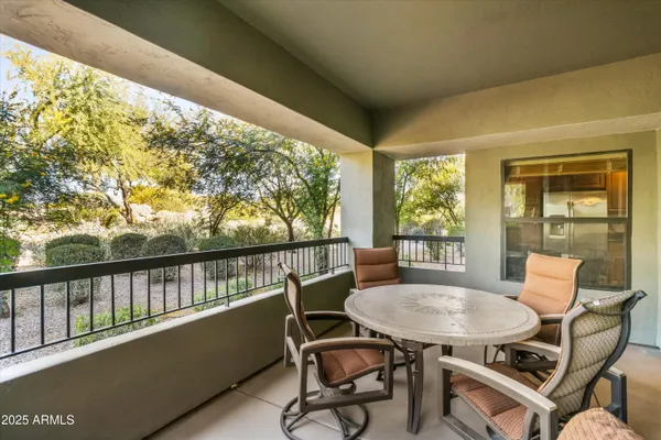 a view of a chairs and table in patio