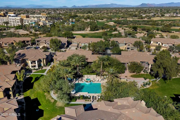 an aerial view of residential building with outdoor space and ocean view