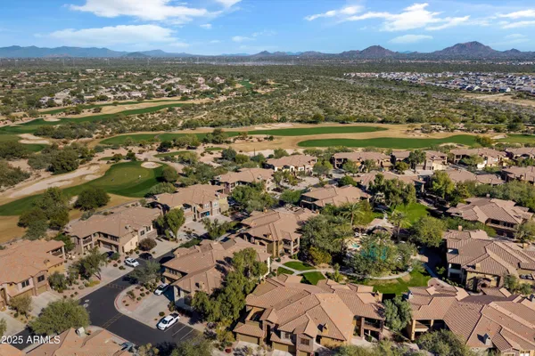 an aerial view of a residential houses with outdoor space